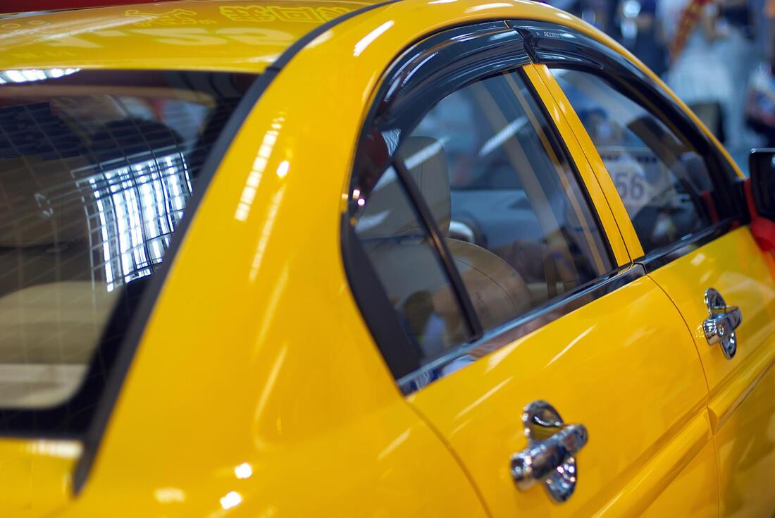 Picture of a yellow car with tinted windows